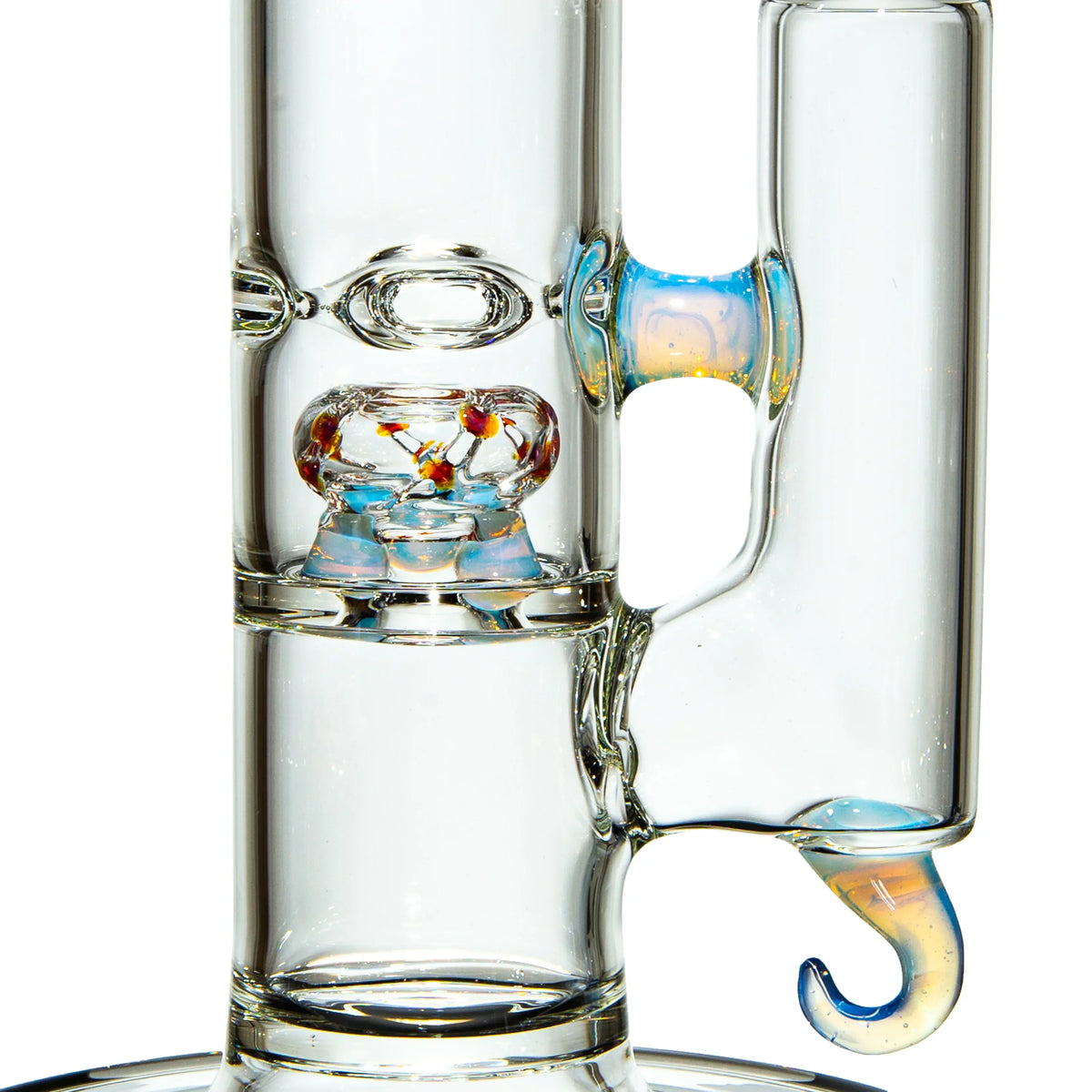 Close-up of a clear glass water pipe with colorful percolator and unique hook handle.