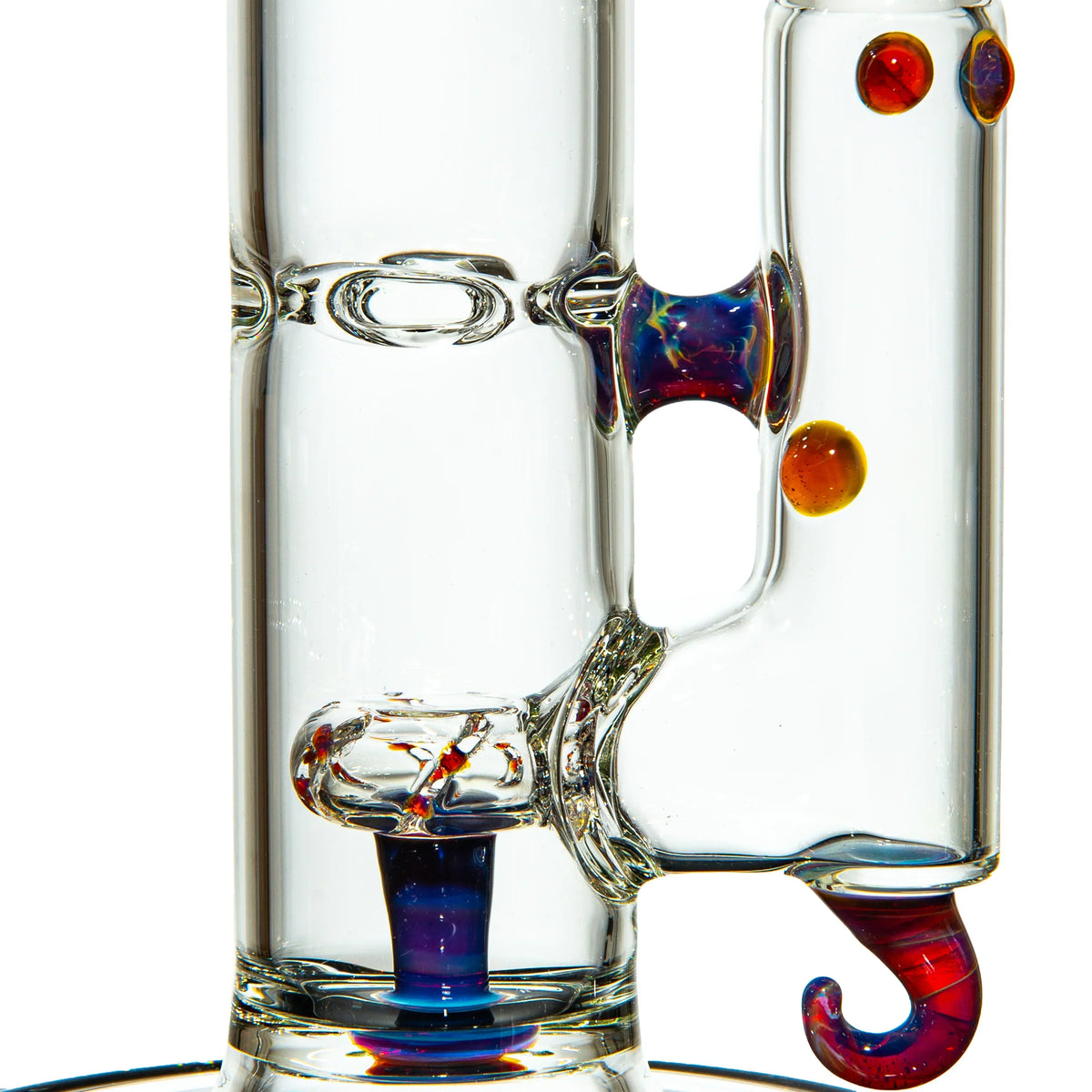 Close-up of a clear glass water pipe with colorful accents and decorative hook detail