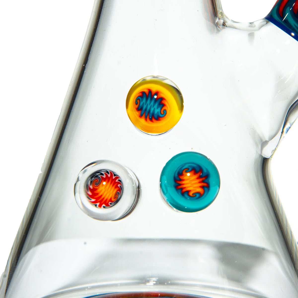 Close-up of colorful heady glass art details on a clear glass water pipe