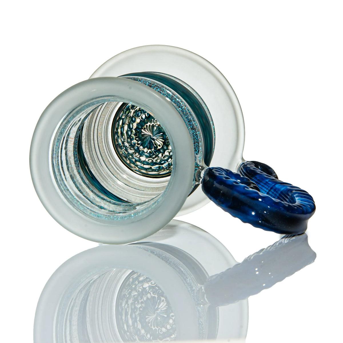 Close-up of artistic glass pipe with blue and clear details, intricate textured base