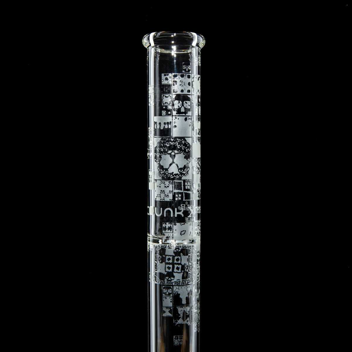 Tall clear glass bong with intricate etched geometric designs on the tube, black background.
