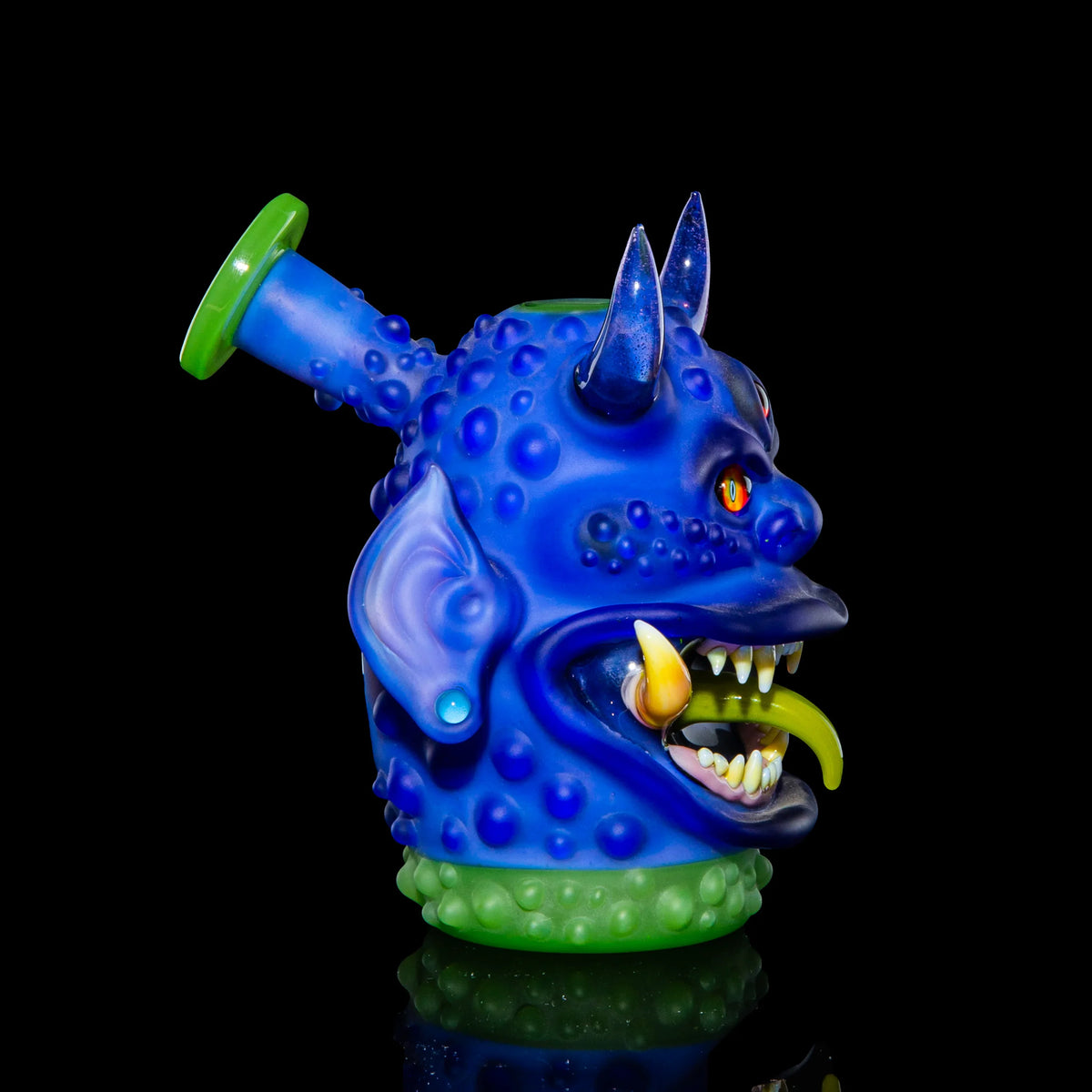 Heady glass pipe shaped like a blue monster with horns, fangs, and textured details.