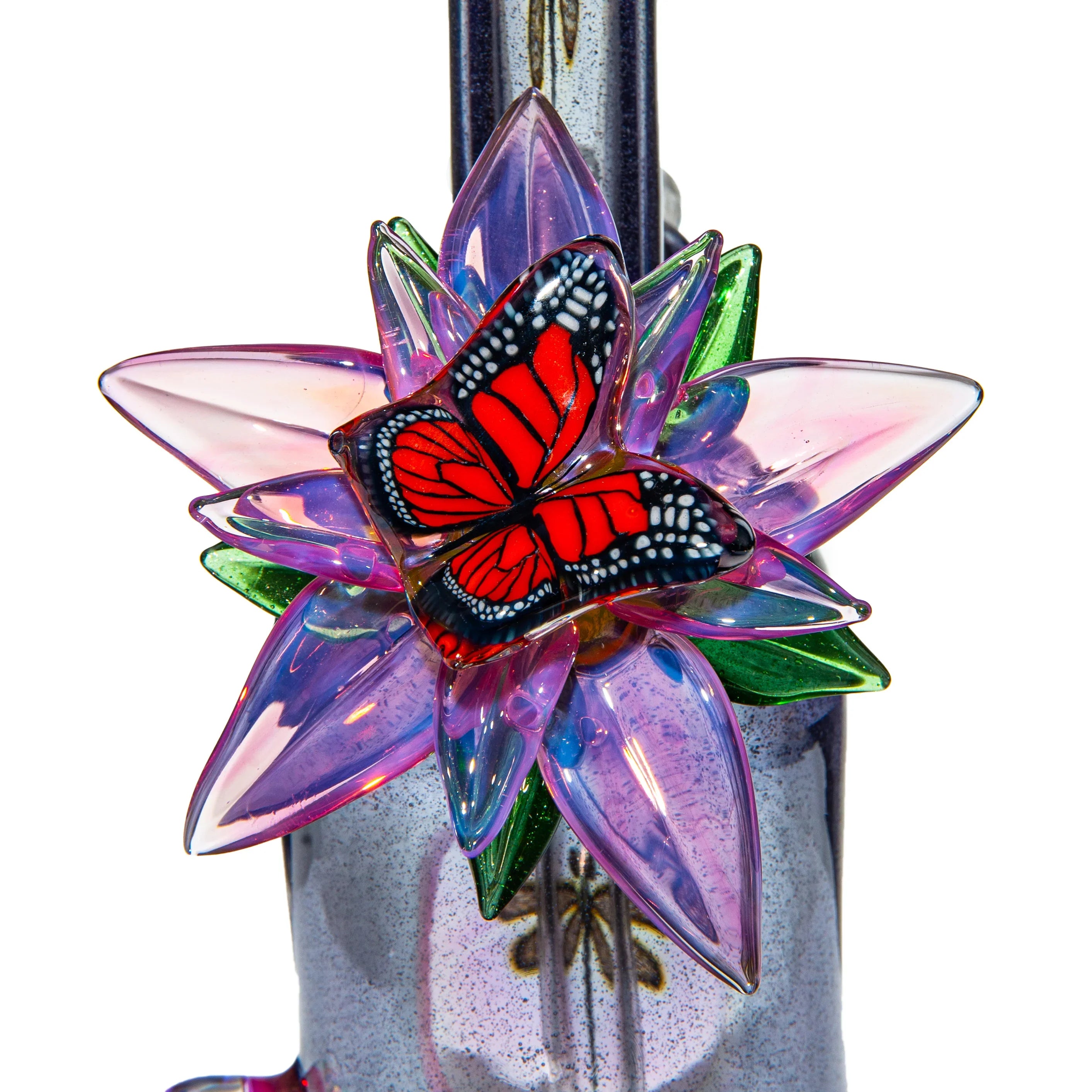 Close-up of a colorful glass flower with a red butterfly accent on a glass pipe.