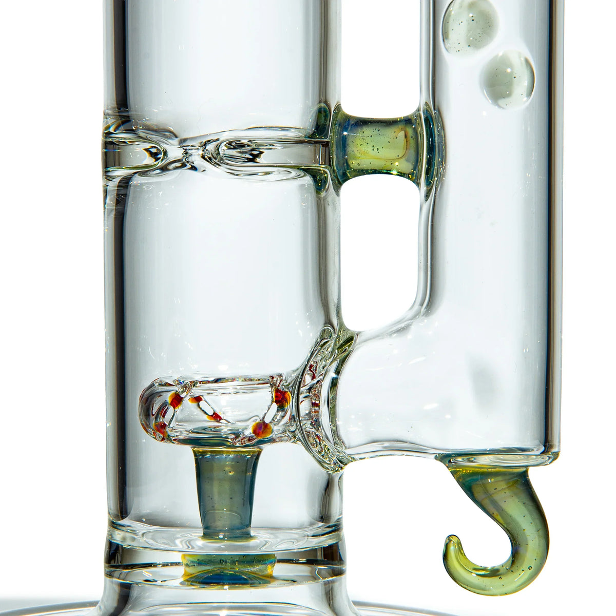Close-up of a clear glass water pipe with decorative accents and a unique hook-shaped feature.