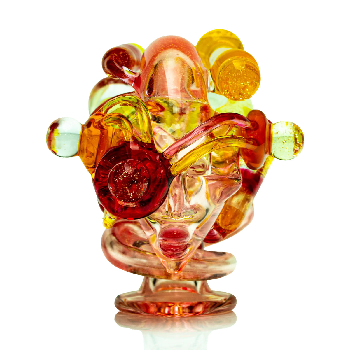 Heady glass sculpture in vibrant yellow, orange, and red tones on white background