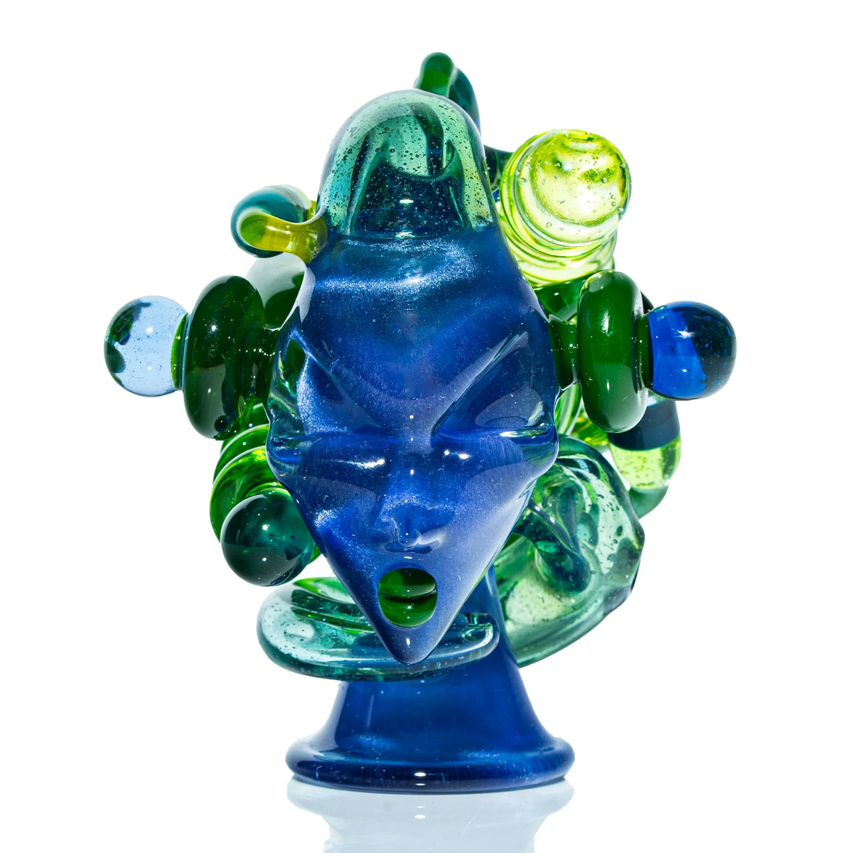 Artistic blue and green glass sculpture with face design, heady glass art close-up