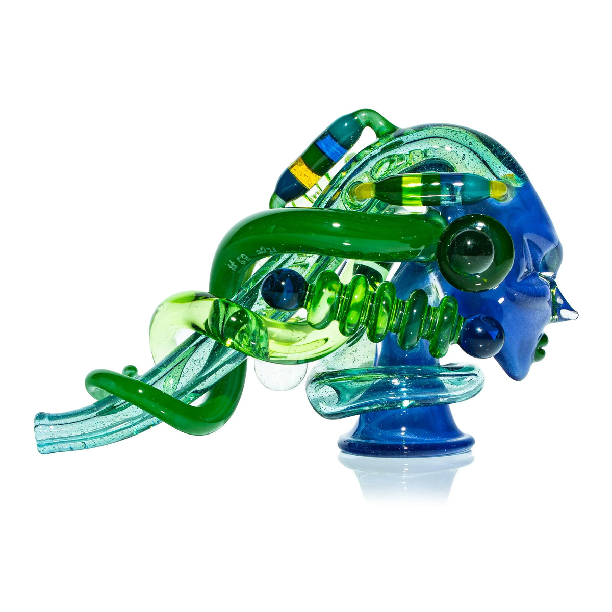 Blue and green heady glass art pipe with intricate sculpted details on white background