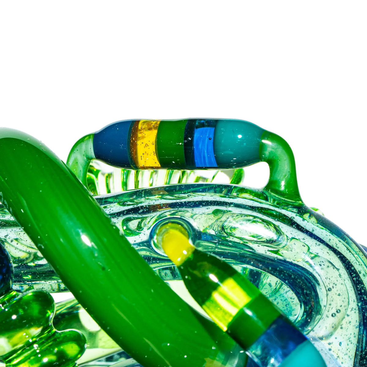Close-up of intricate blue and green heady glass pipe with colorful accents
