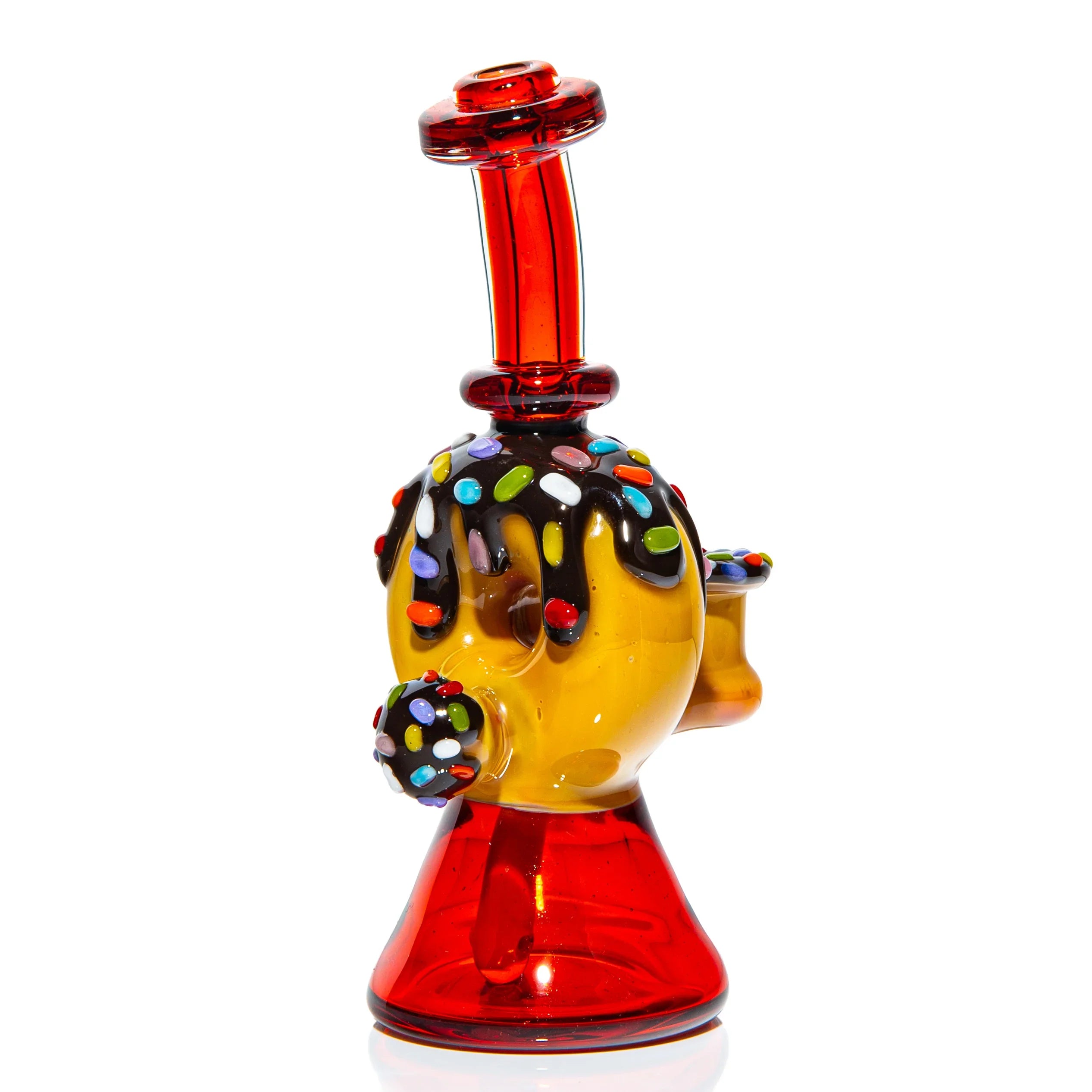 Colorful heady glass dab rig with red base, yellow body, and sprinkle detail on top