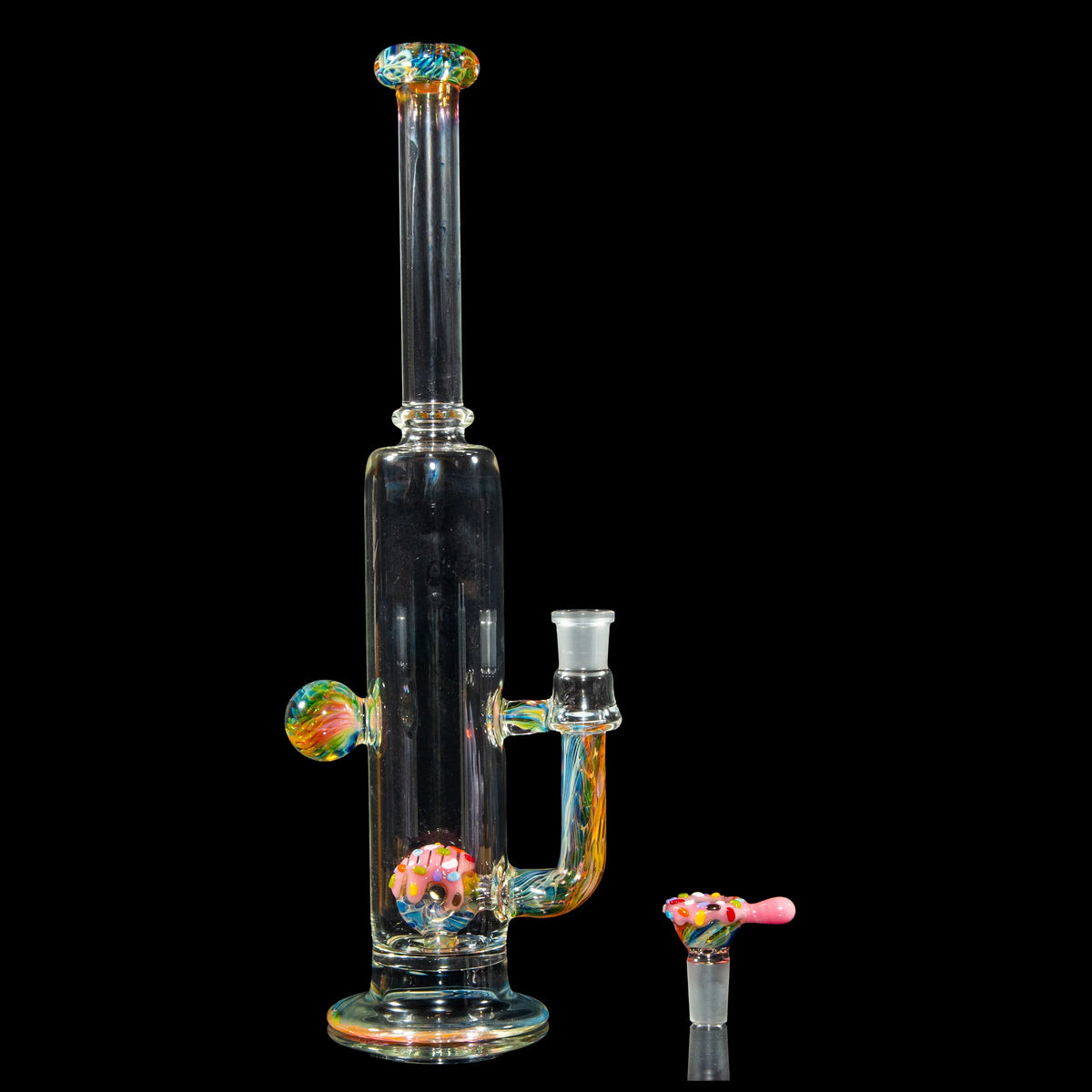 Colorful glass water pipe with donut-themed bowl and accents on a black background