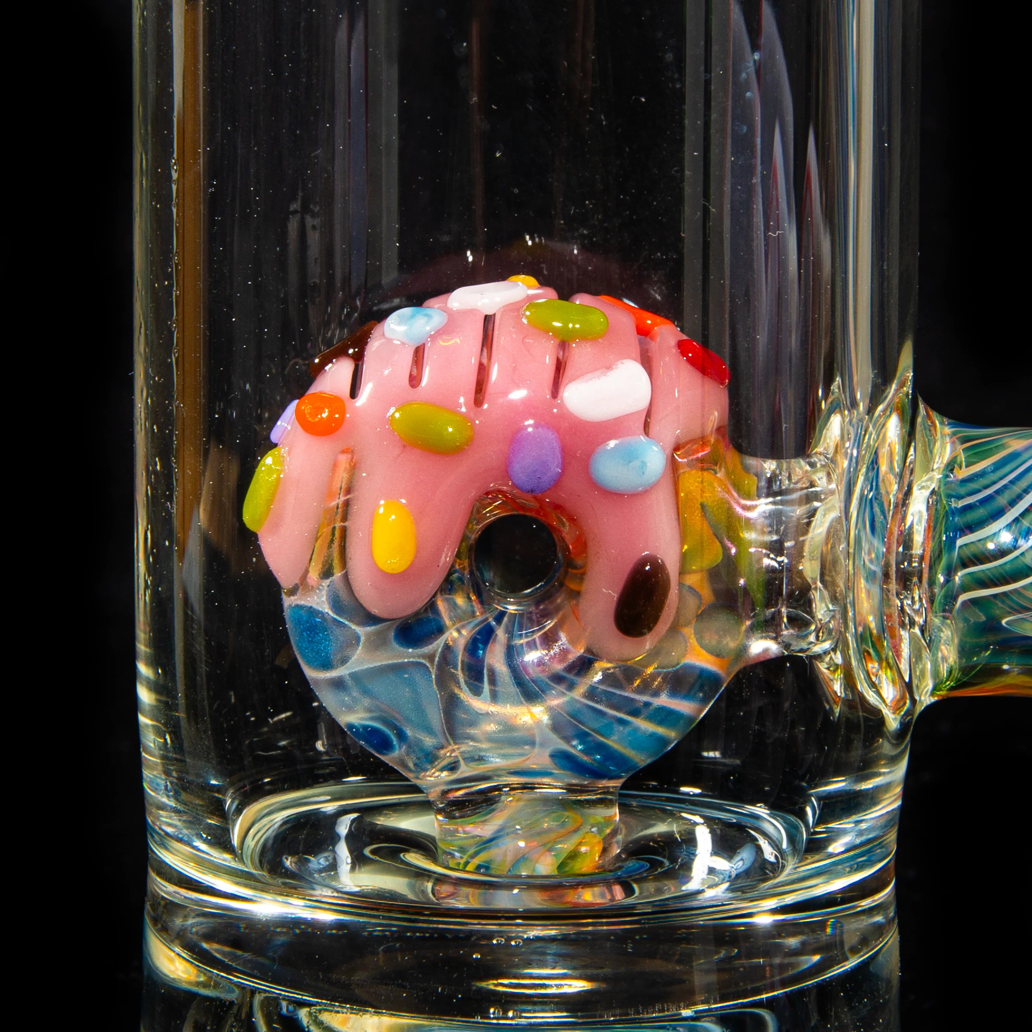 Close-up of colorful donut-inspired glass percolator inside a water pipe