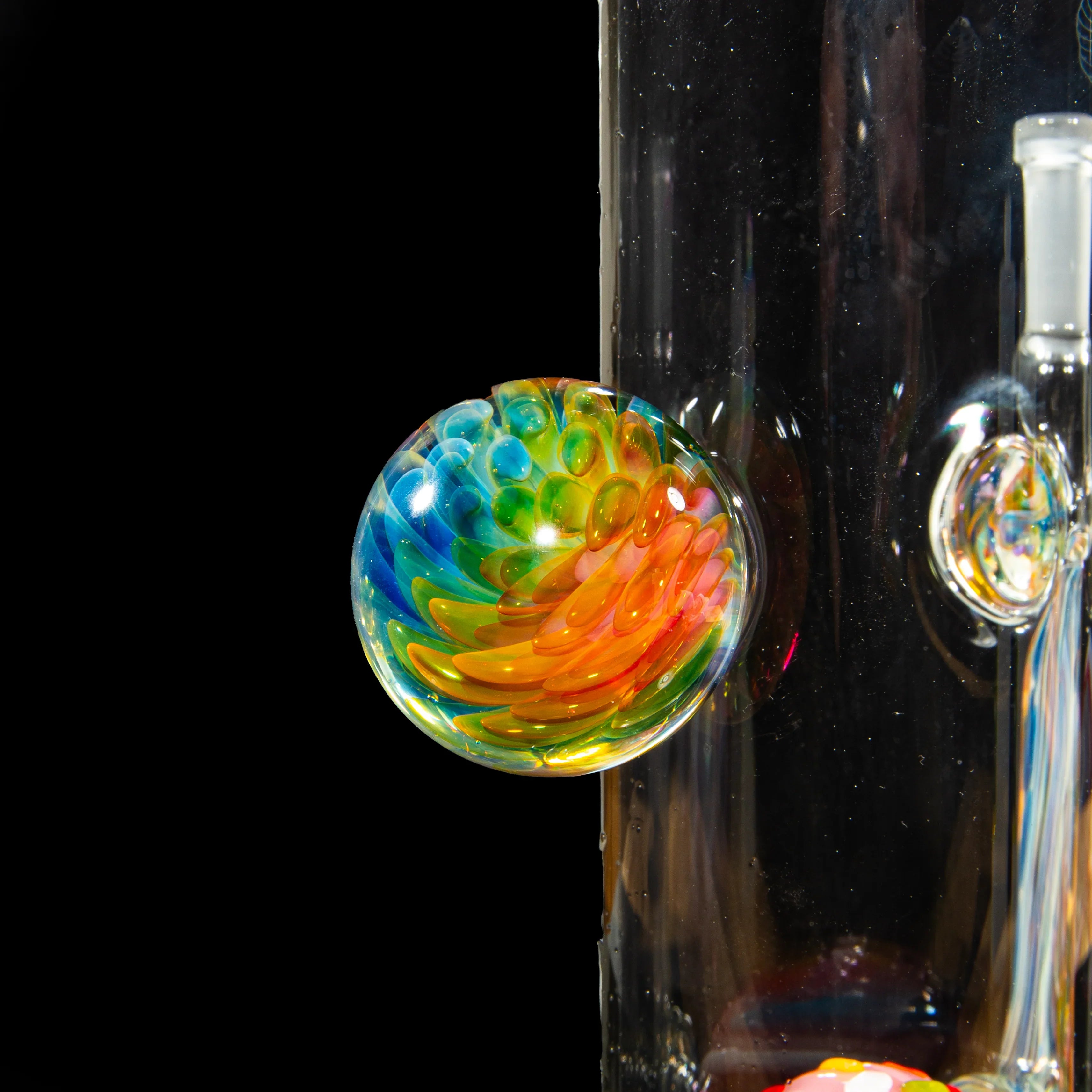 Close-up of colorful heady glass art detail on a clear glass water pipe