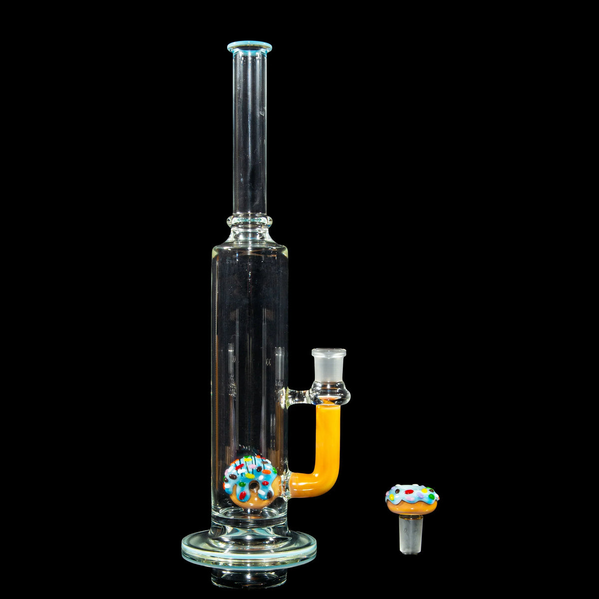 Clear glass water pipe with yellow accent and donut-shaped glass detail, on black background.