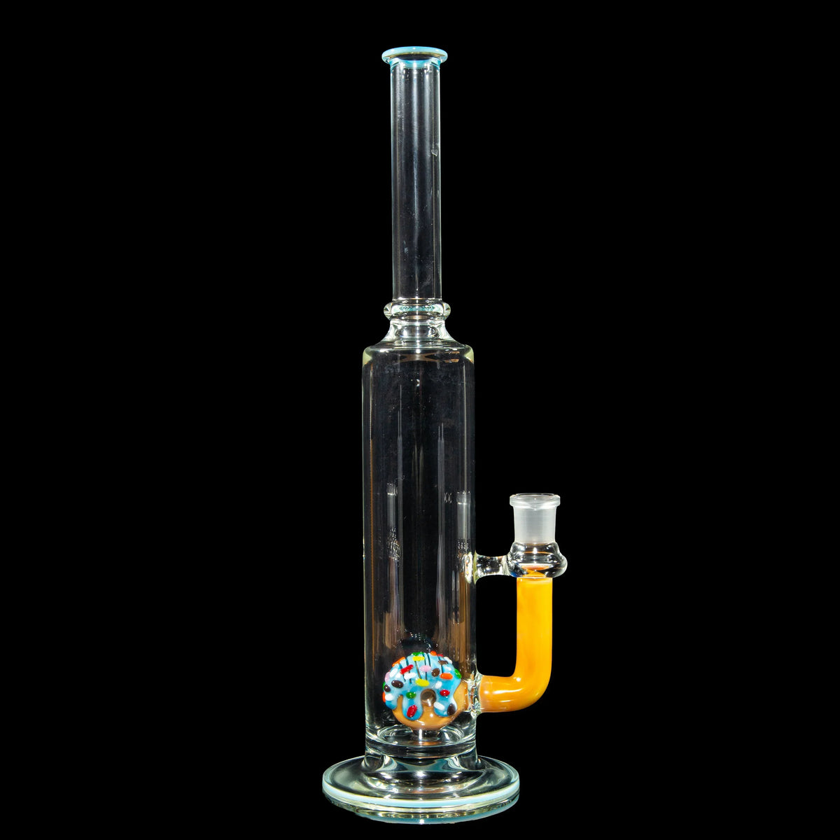 Clear glass water pipe with a colorful donut percolator and yellow accent on black background