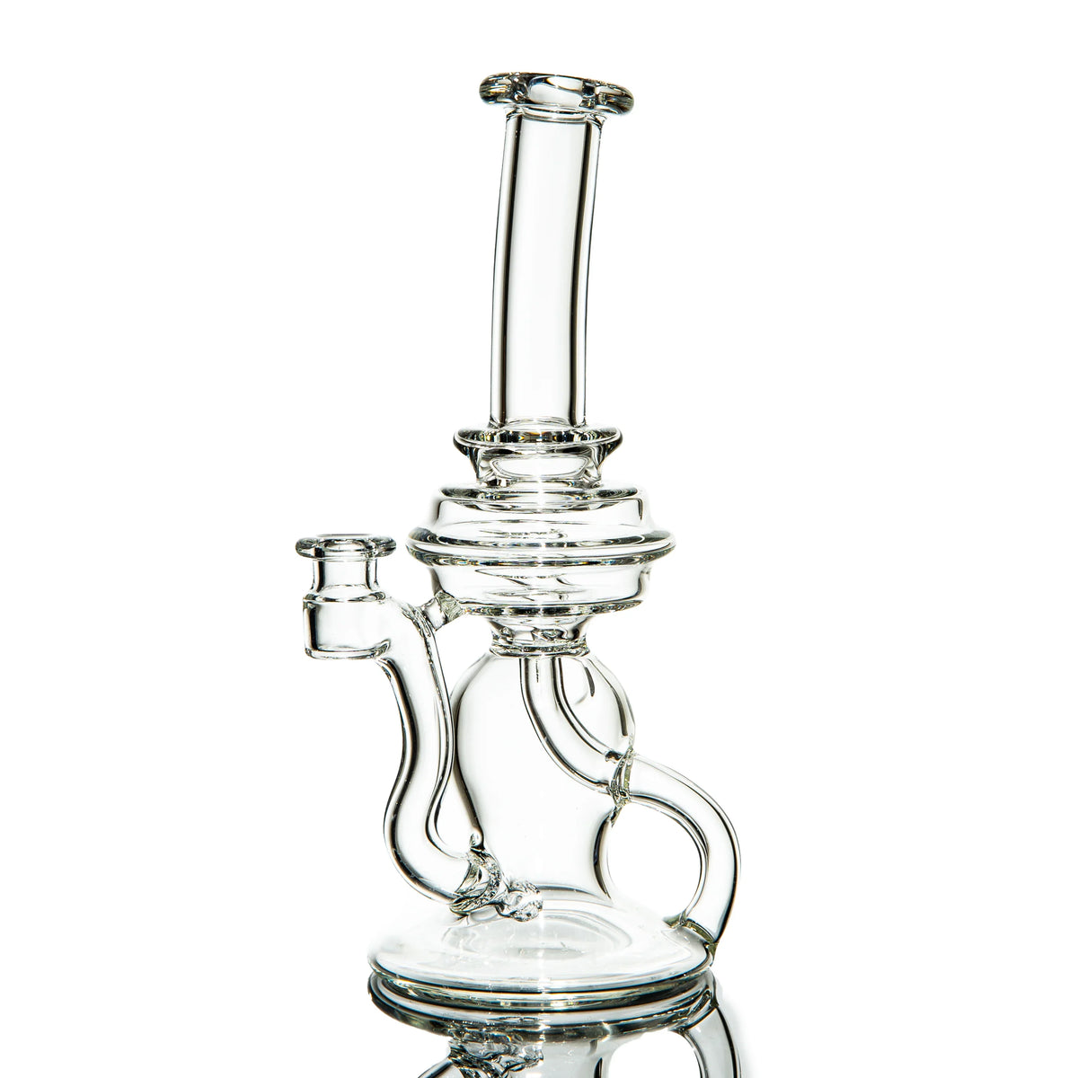 Clear glass recycler water pipe with intricate tubing against white background