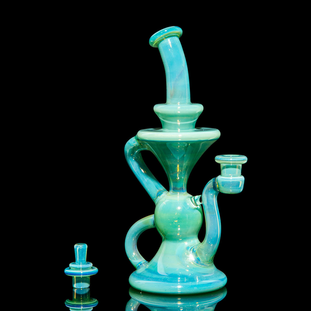 Aqua blue heady glass water pipe with intricate design on black background