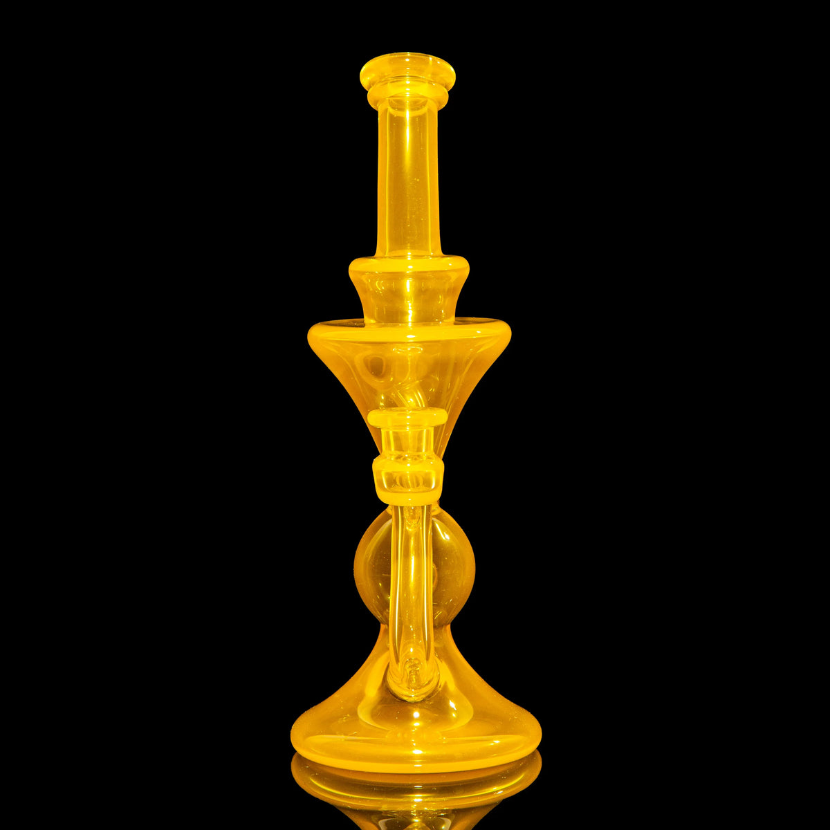 Heady yellow glass water pipe with artistic design on black background