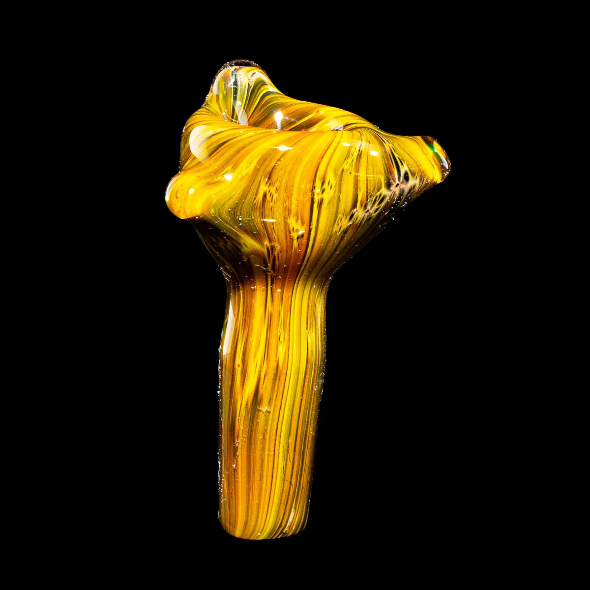 Hand-blown yellow glass pipe with swirling patterns on black background