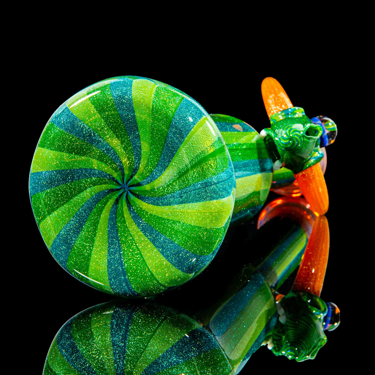 Hand-blown green and blue glass pipe with spiral design and orange accents on black background.