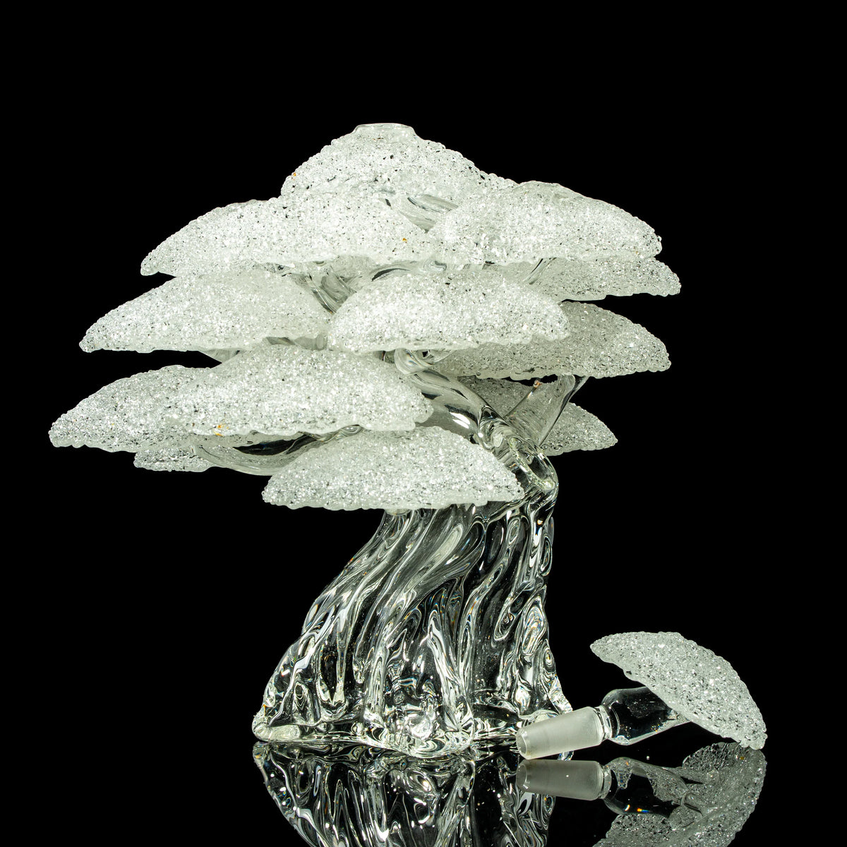 Intricate clear glass art piece shaped like a tree with sparkling textured branches