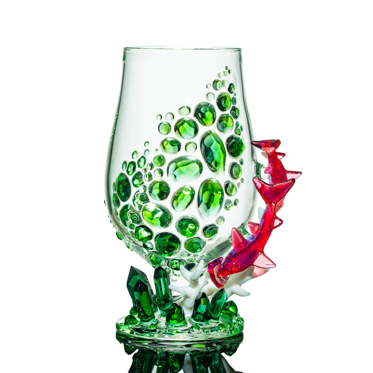 Decorative glass cup with green gem accents and red sculpted dragon, crystal base