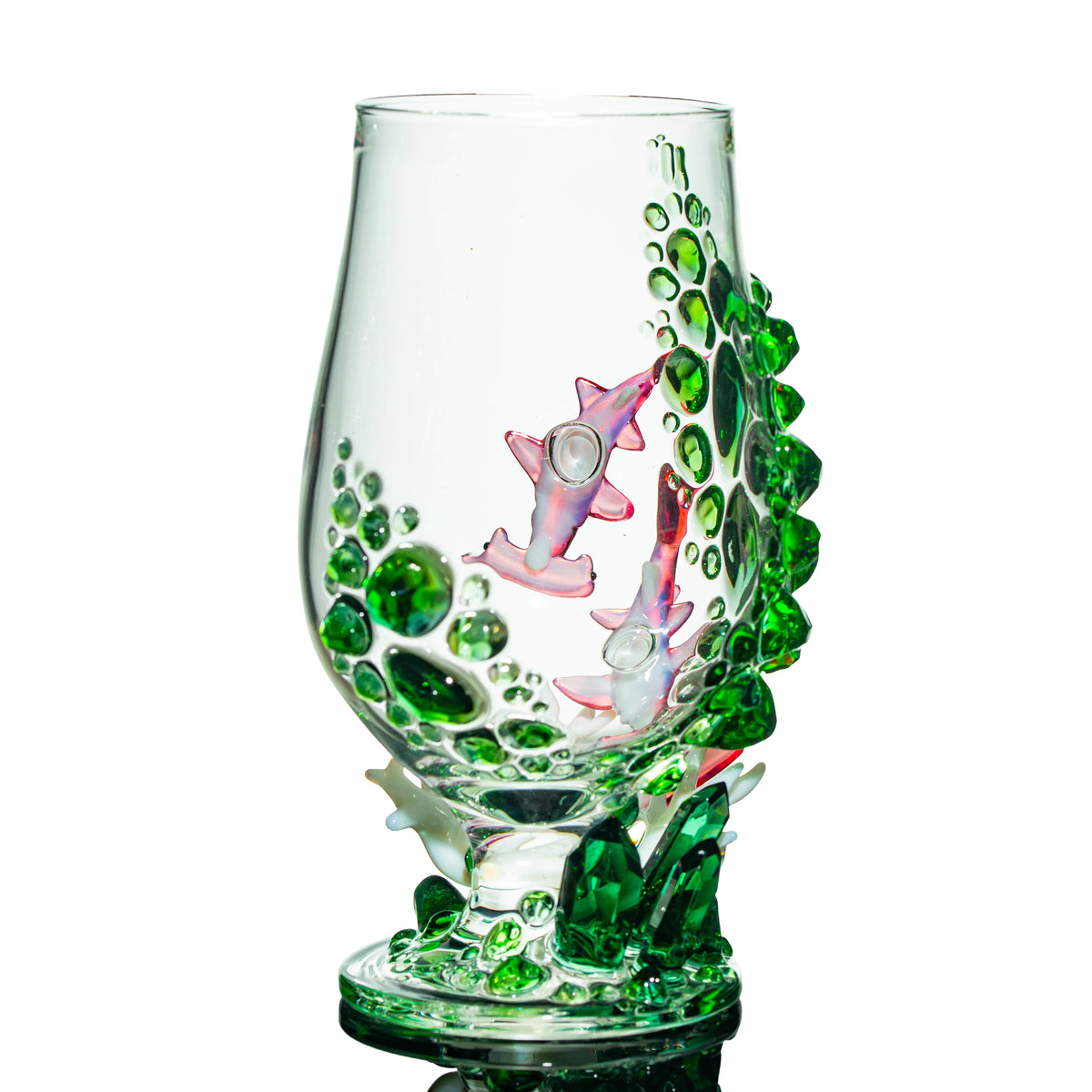 Hand-blown glass art cup with green crystal accents and decorative sharks design