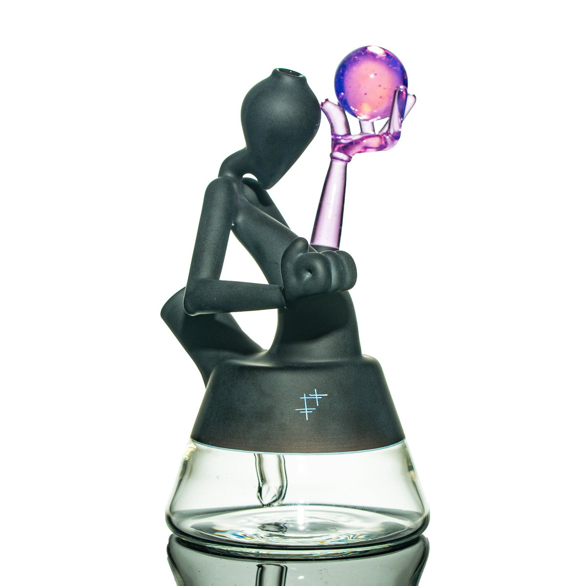 Hand-blown glass water pipe with abstract black figure holding purple orb, clear base