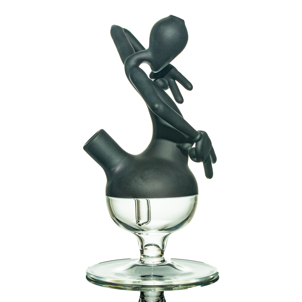 Black and clear heady glass dab rig with sculpted figure design on white background