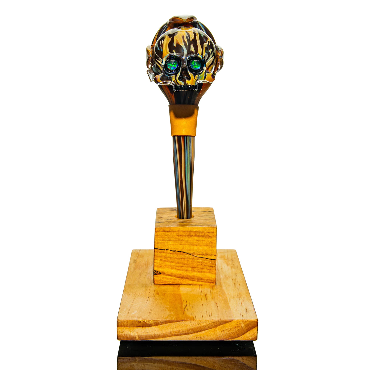 Head glass pipe with intricate skull design, vibrant colors, displayed on wooden stand