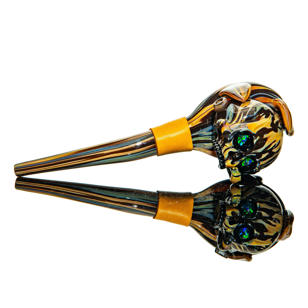 Hand-blown glass pipe with skull design, colorful stripes, and reflective surface