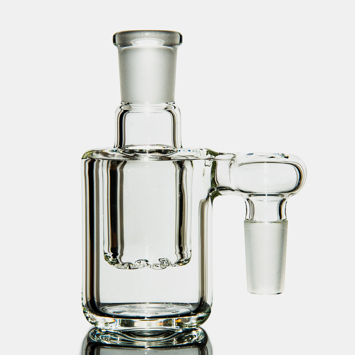 Clear glass ash catcher with percolator for water pipe or bong on white background