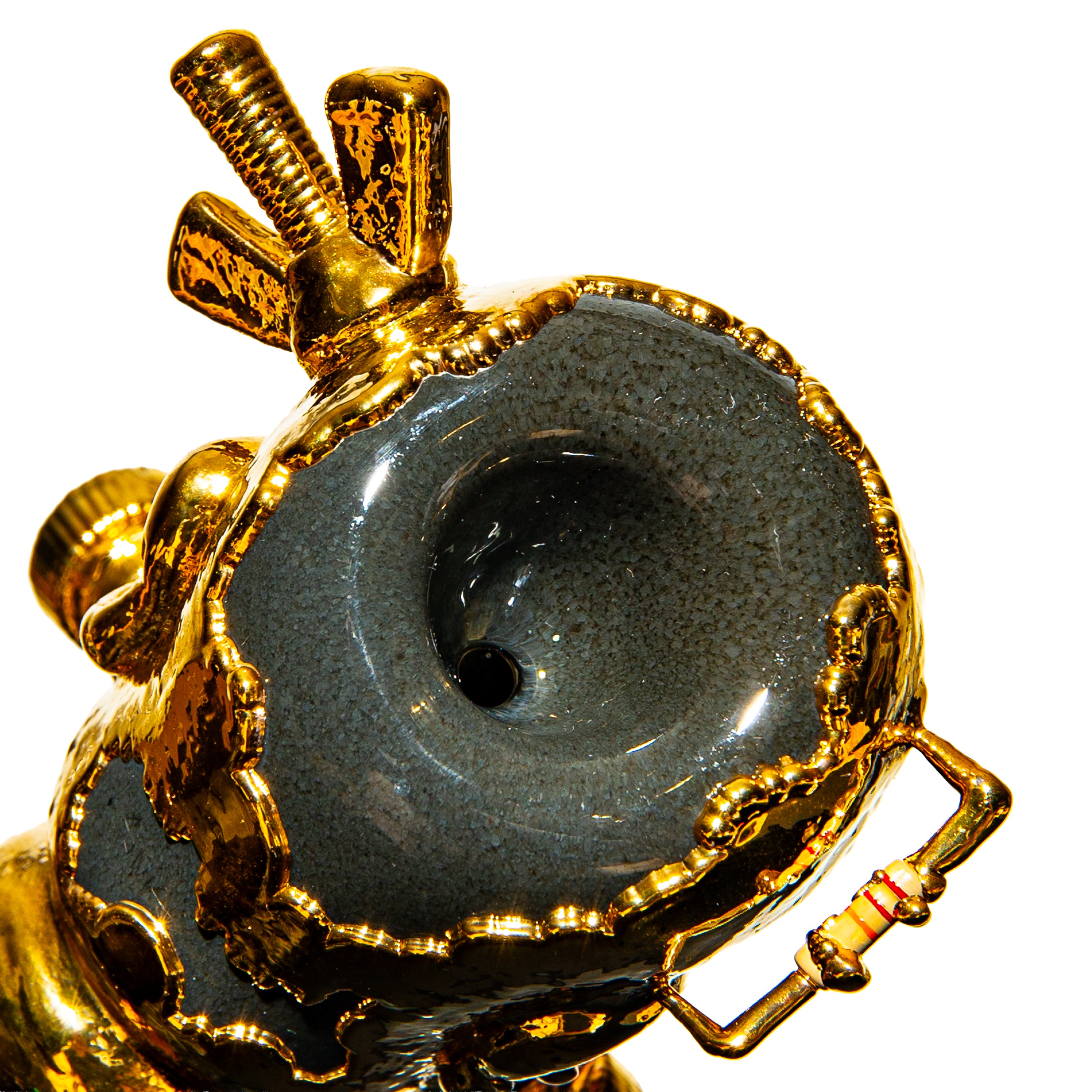 Close-up of luxury heady glass pipe with gold accents and intricate textured details