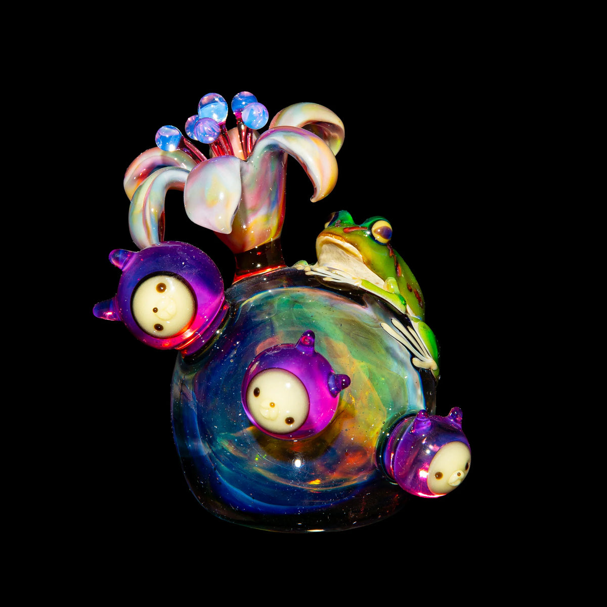 Handcrafted heady glass art pipe with colorful flower, frog, and alien accents on black background