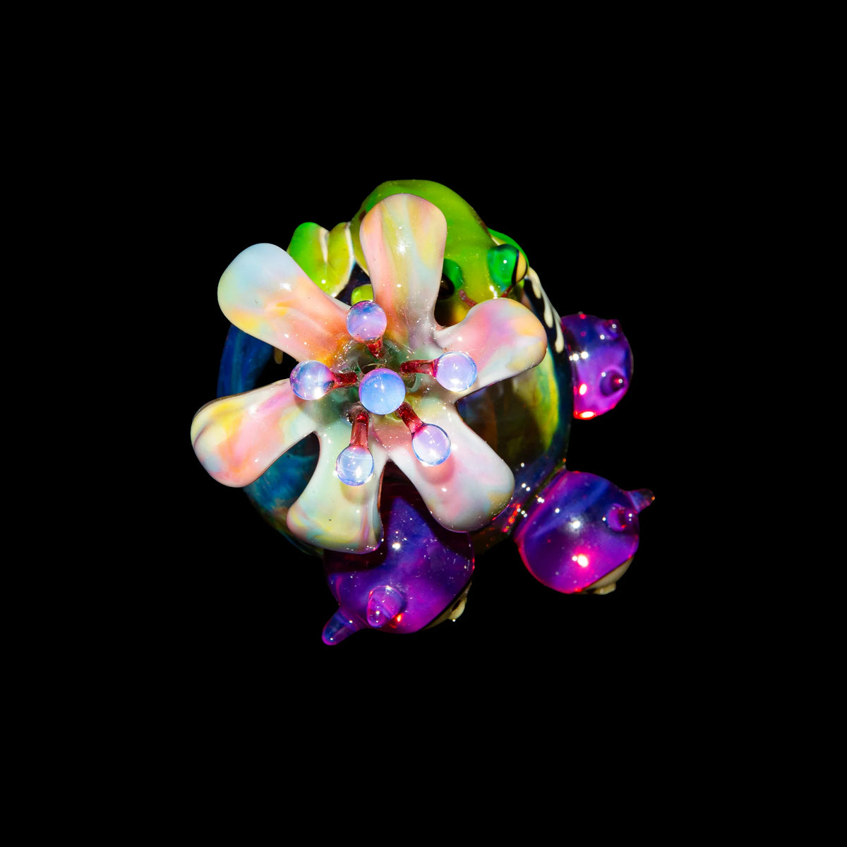 Colorful heady glass pipe with flower-shaped accents and iridescent details on black background
