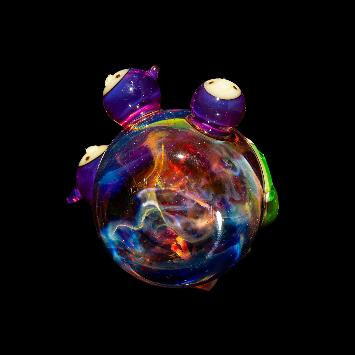 Colorful heady glass art pipe with galaxy-inspired design and purple accents on black background.
