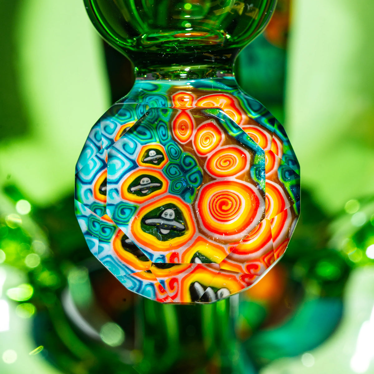 Close-up of colorful heady glass art with psychedelic patterns and UFO designs