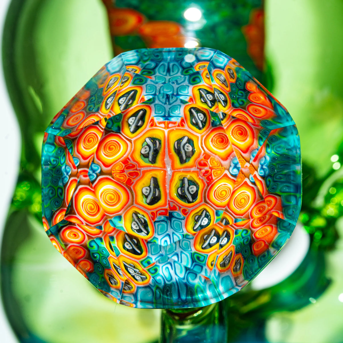 Close-up of colorful faceted glass art with intricate patterns and psychedelic designs