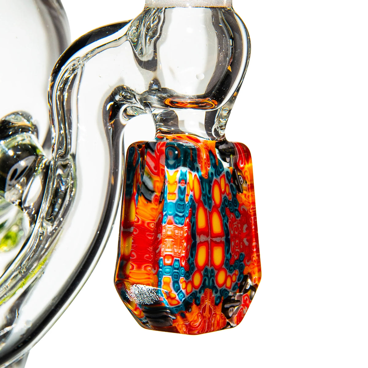 Close-up of colorful heady glass attachment with intricate red, blue, and yellow patterns