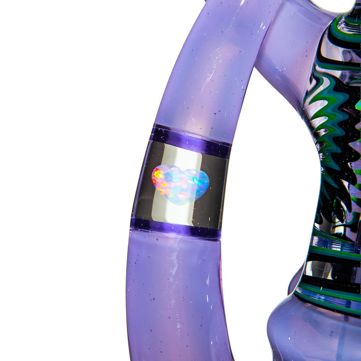 Close-up of purple glass pipe with iridescent heart detail and artistic patterns