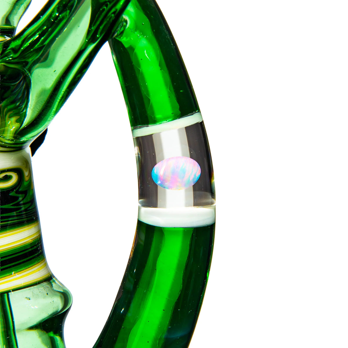 Close-up of green glass pipe with intricate patterns and opal accent detail