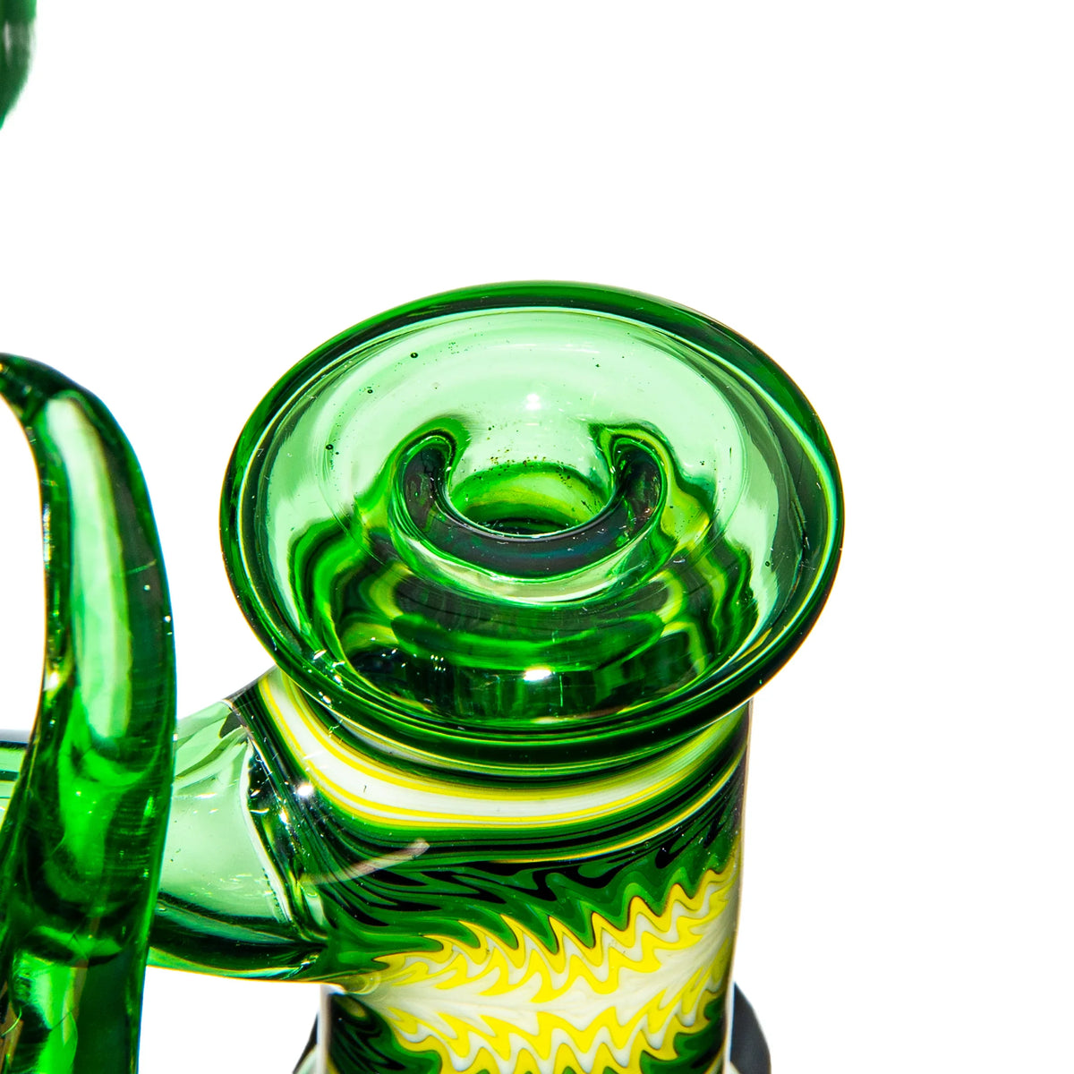 Close-up of a green and yellow heady glass water pipe with intricate patterns on white background