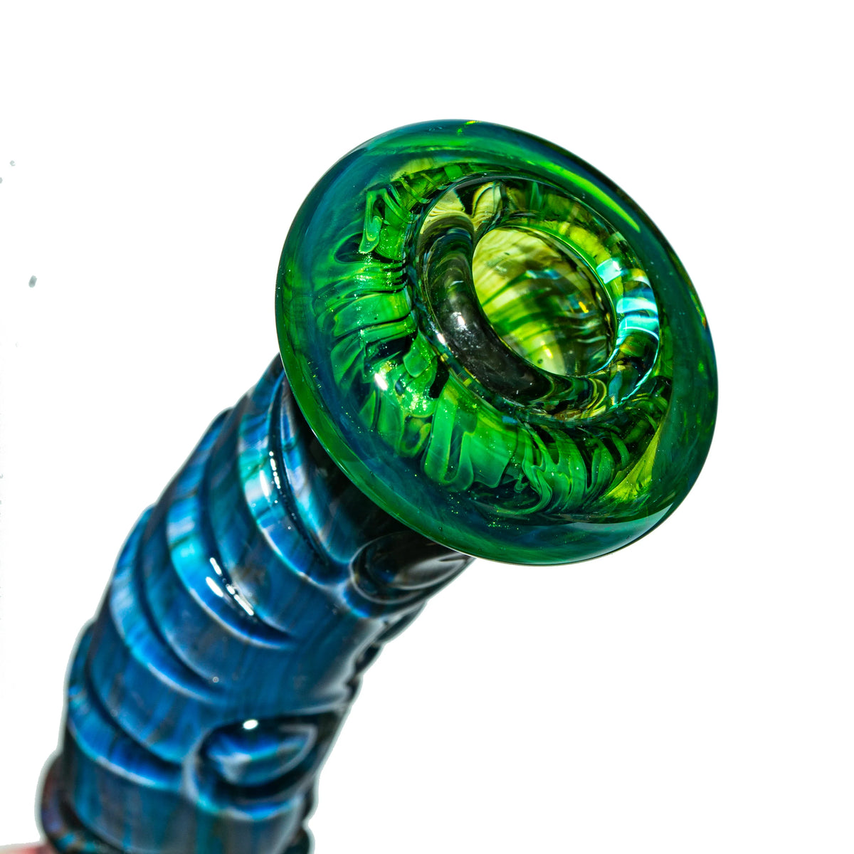 Closeup of colorful heady glass pipe featuring green and blue artistic details