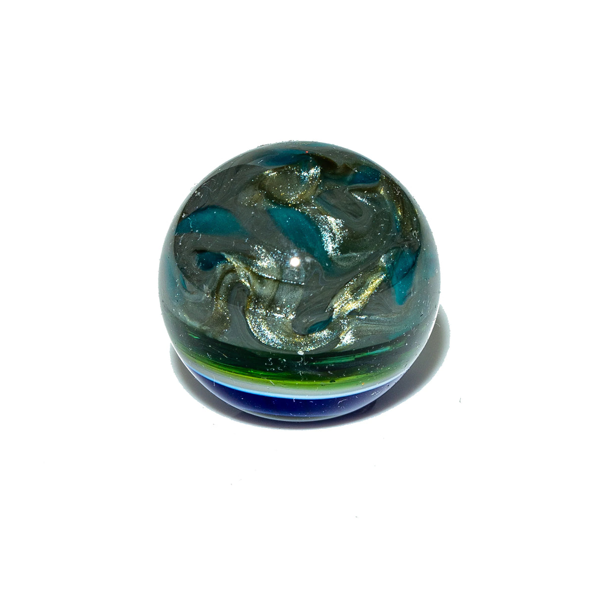Handblown glass marble with blue, green, and silver swirling patterns on white background