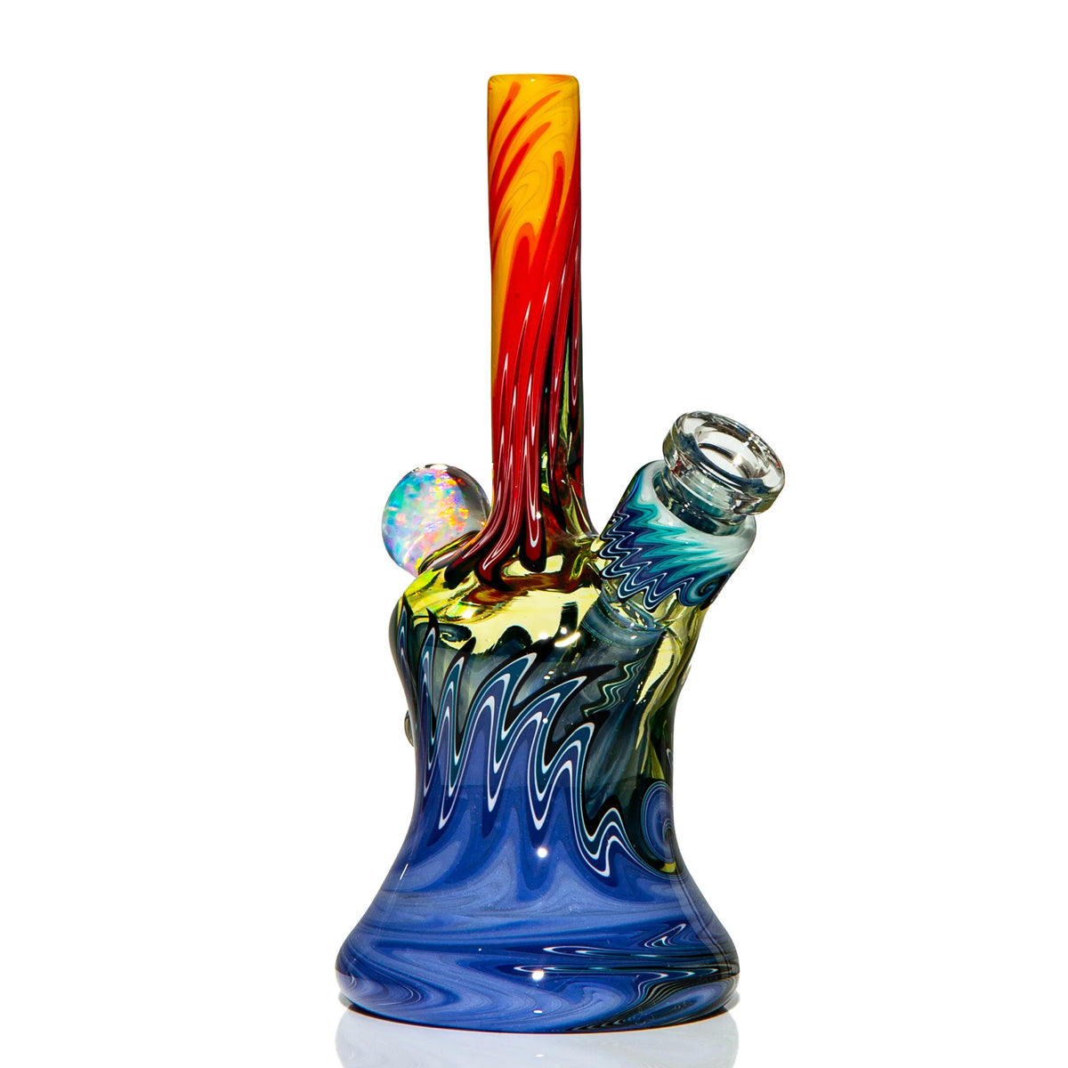 Colorful heady glass water pipe with swirling blue, yellow, and red patterns, marble accent