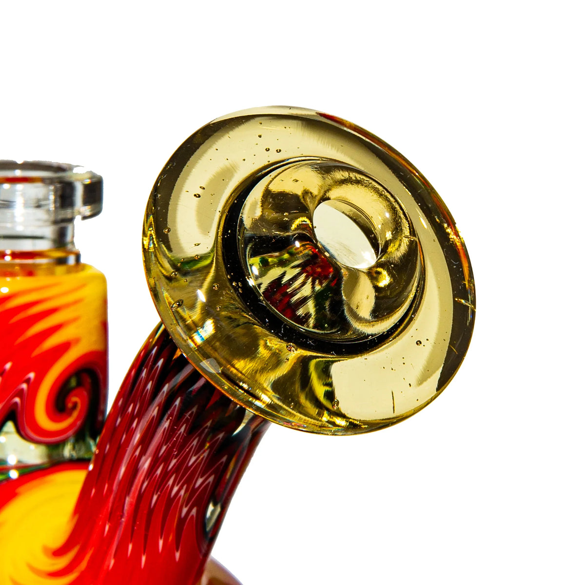 Close-up of colorful heady glass water pipe with gold accents and vibrant red swirls
