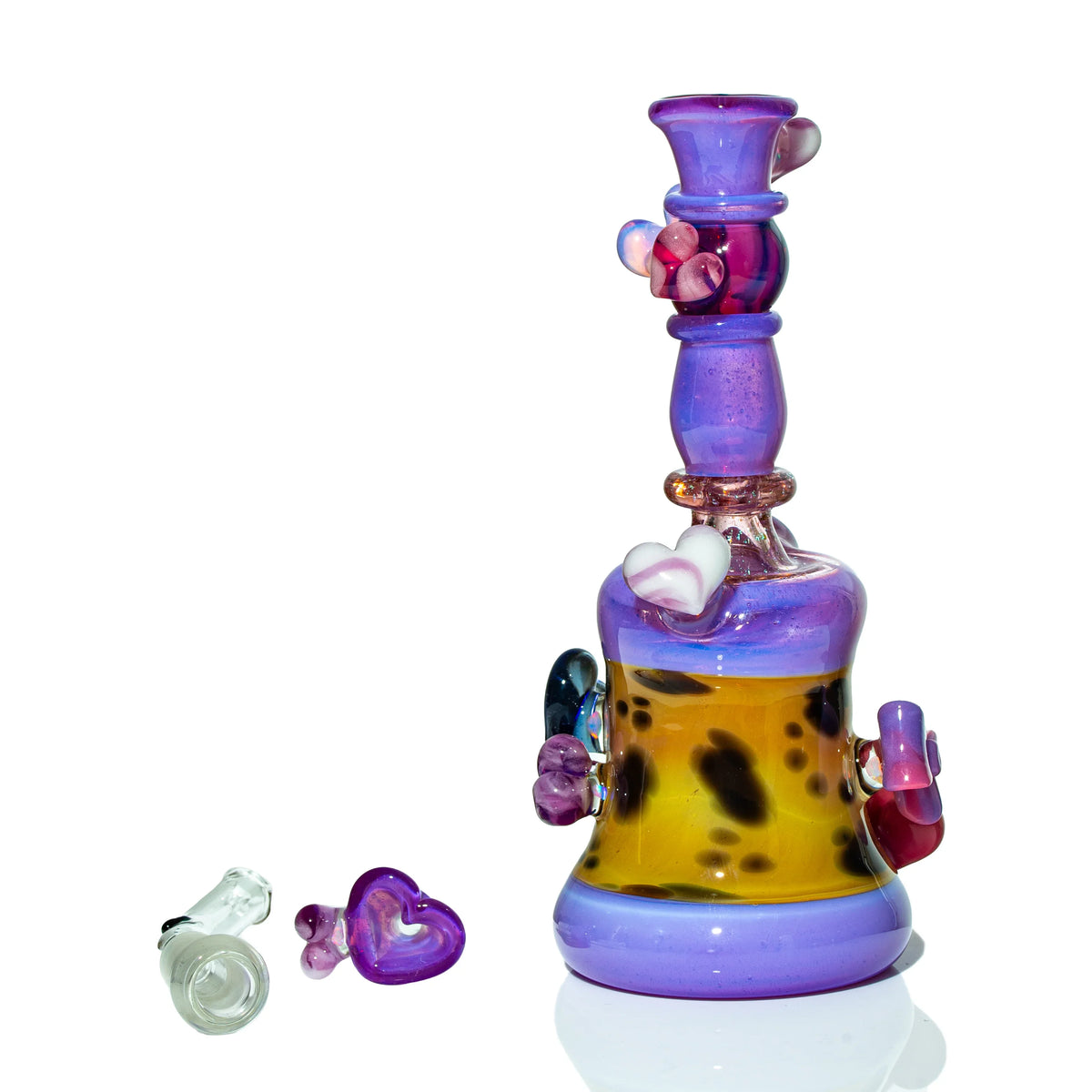 Colorful heady glass water pipe with heart accents, purple and yellow design, on white background