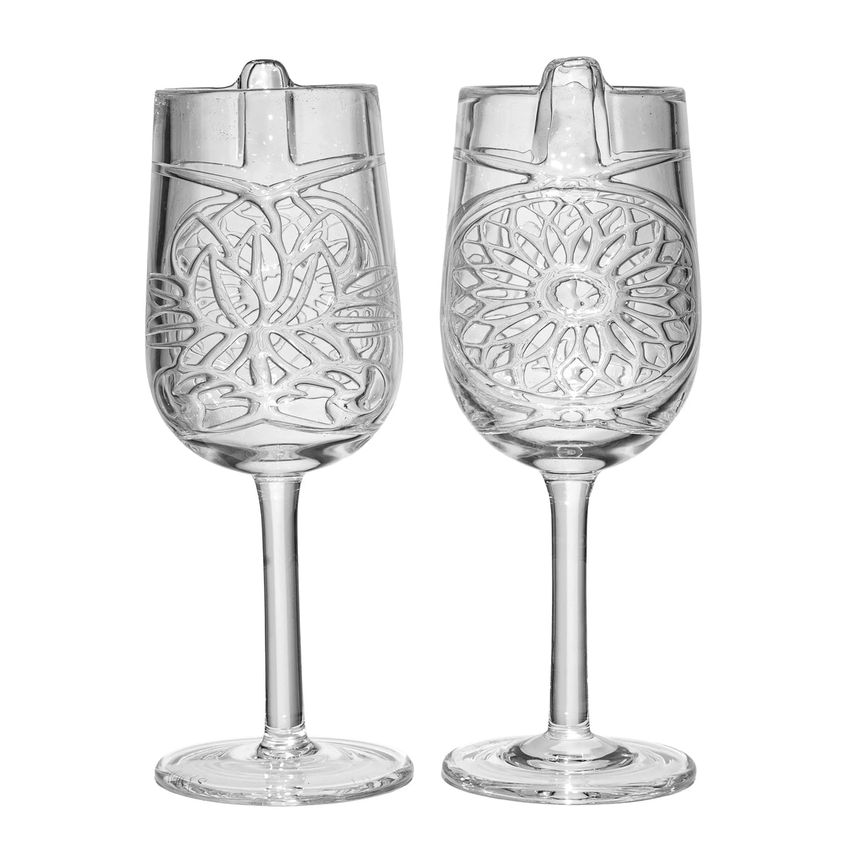 Two clear etched wine glasses with intricate geometric patterns and angled mouthpieces
