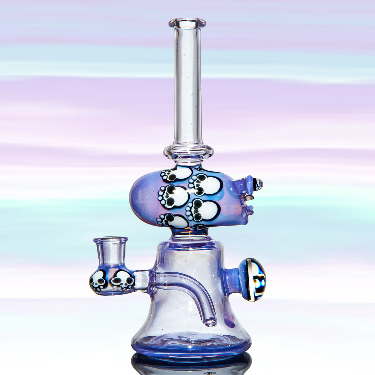 Heady glass water pipe with skull design, purple and clear colors, artistic smoking accessory