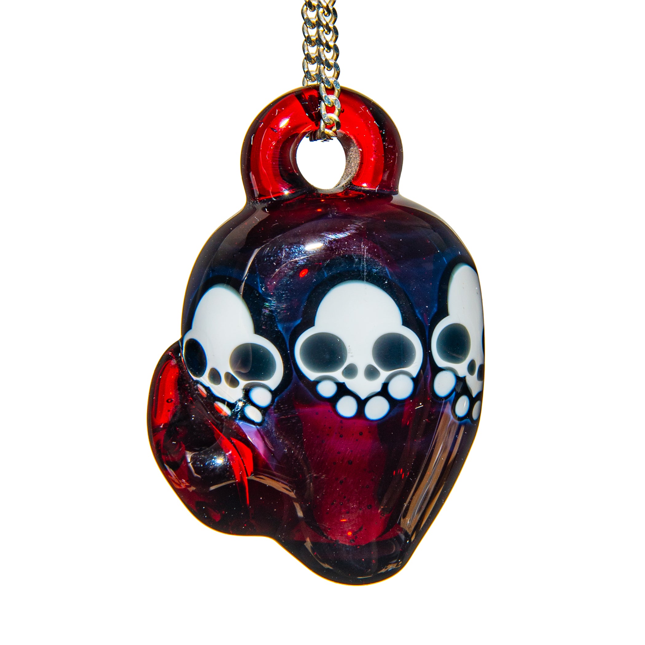 Hand-blown glass pendant with skull designs, red and blue coloring, on a metal chain