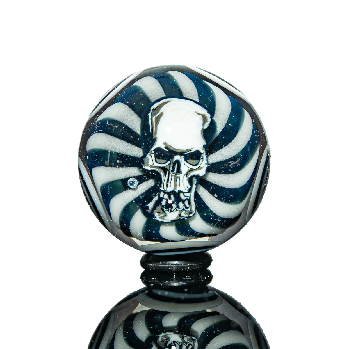 Handcrafted glass marble with skull design and black and white spiral pattern